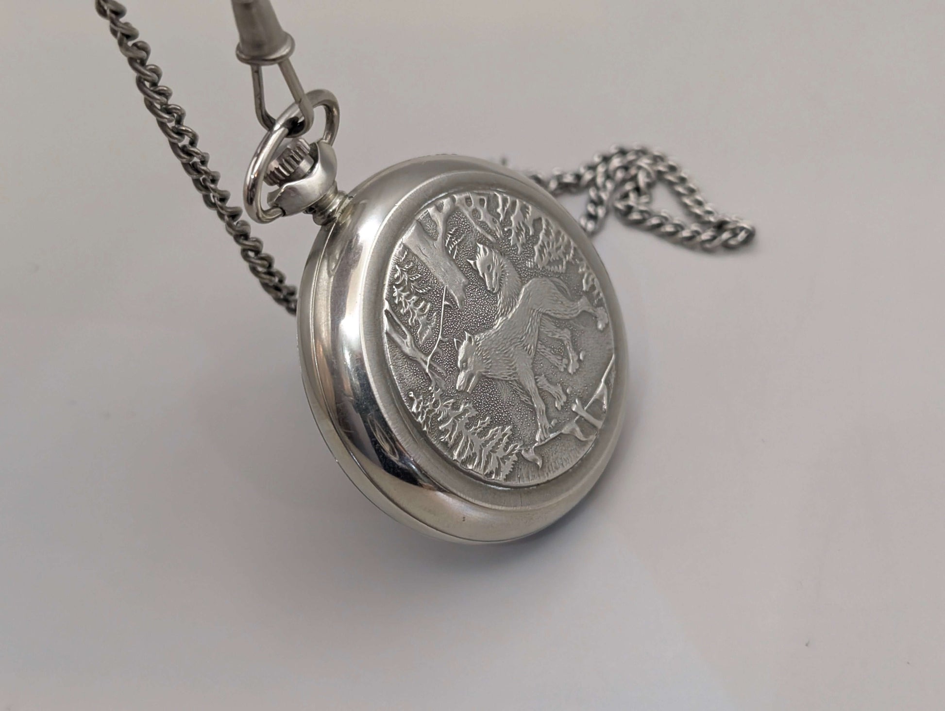 Molnija pocket watch with "Wolves in the Forest" engraving, nickel-plated brass, silver-tone, from 1980s Soviet Union.