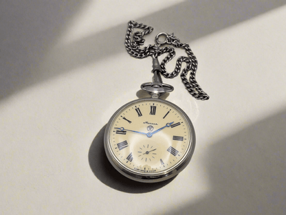 Molnija pocket watch with silver chain, featuring "Wolves in the Forest" engraving, Soviet-era design from the 1980s.